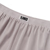 Close-up of the Y,IWO x Ace Hotel grey microfiber quad shorts showing the elastic gathered waistband, woven Y,IWO logo label, and lightweight athletic fabric.